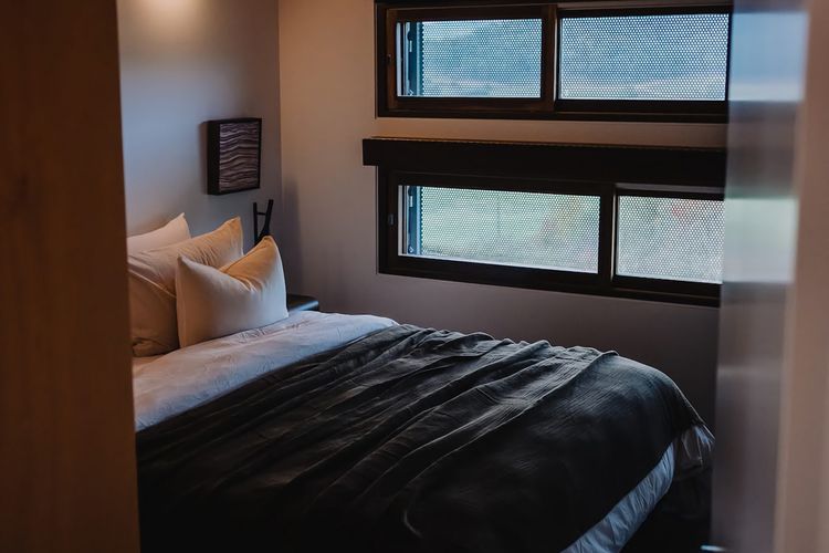 Bedrooms intentionally paired back - where natural materials, soft light, and a restrained palette create calm.