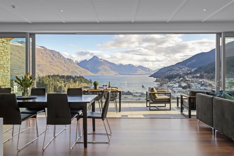 Large living opening to balcony overlooking Queenstown Bay
