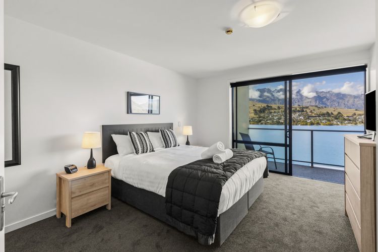 Master bedroom with access to patio and lake views