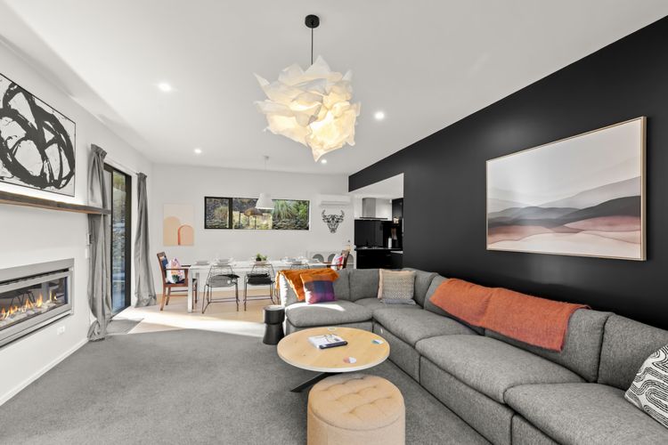 Open plan living with gas fireplace and heatpump