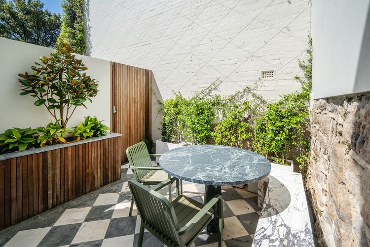 Private outdoor patio surrounded by greenery - perfect for morning coffee or a relaxing evening meal.