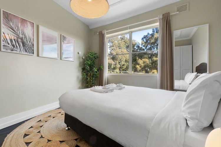 Crisp, white bedding creates a perfect backdrop for a peaceful nights sleep in this beautifully styled room. 