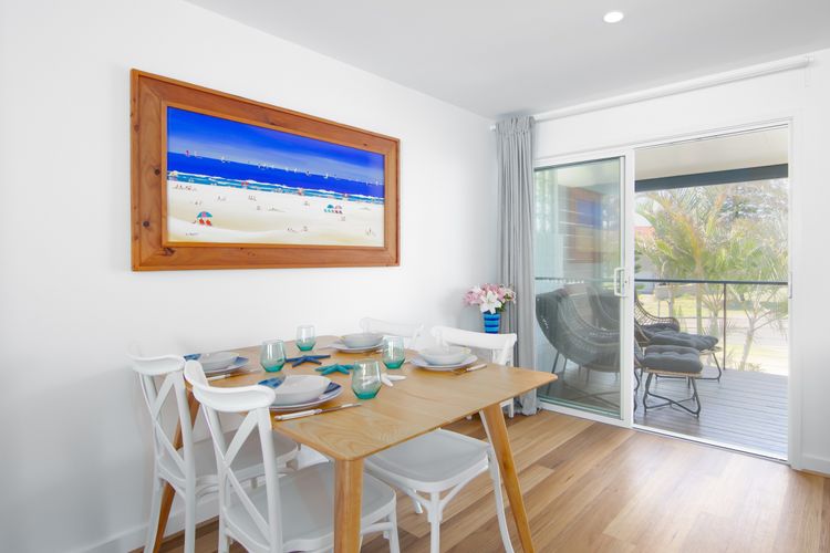 Open plan dining with large sliding doors to balcony