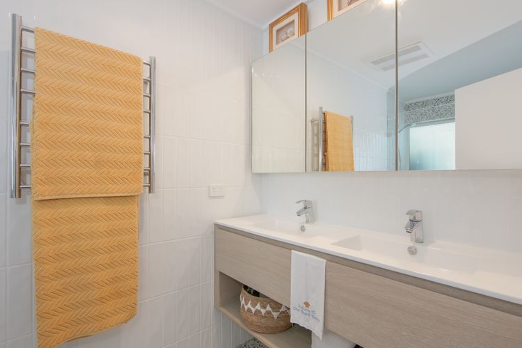 Bathroom with double sinks, shower and toilet