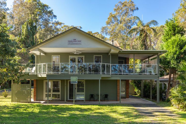 House Exterior with Balcony and Lawn