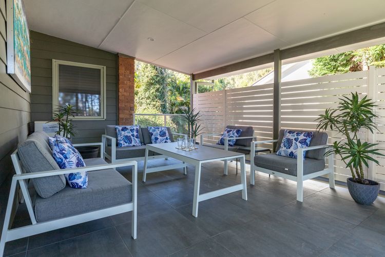 Covered Outdoor Lounge with Cushioned Chairs