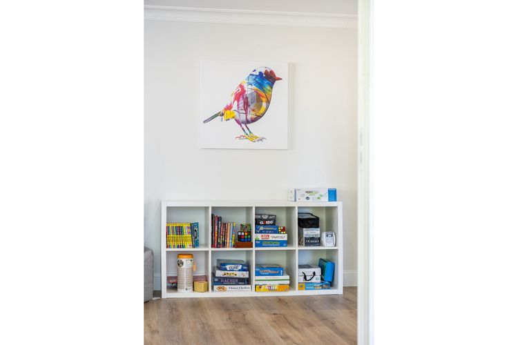 Bookshelf with Bird Artwork