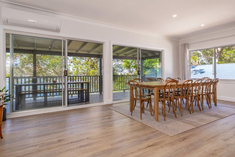 Dining Area with Large Wooden Table and Lake Views