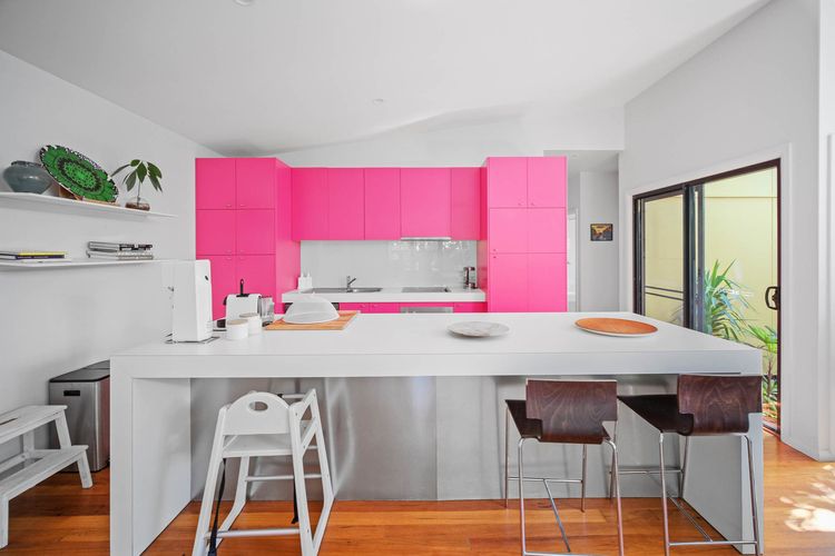 Kitchen with Pink Cabinets and White Island