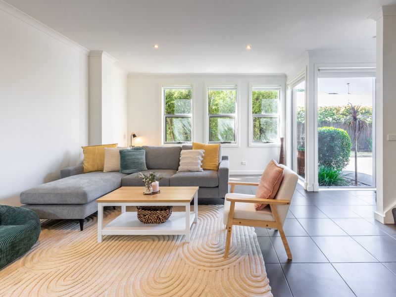 Alternative view of the open living space highlighting the seamless flow toward the exterior sliding doors.