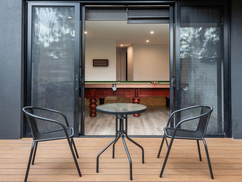 Open glass sliding doors leading from the interior living space to the outdoor deck.