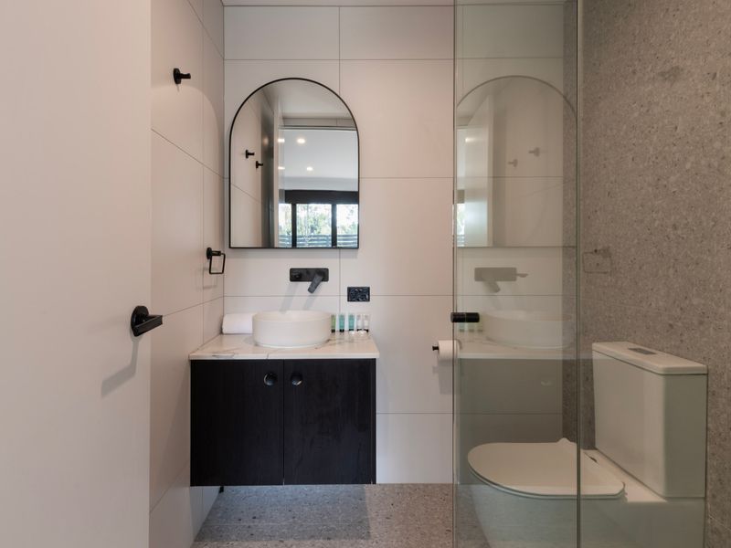 Contemporary bathroom with a sleek vanity and a glass-enclosed shower area.