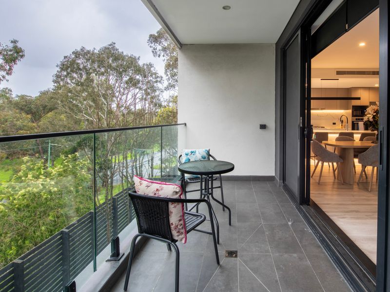 View from the balcony looking over lush trees and surrounding landscape.