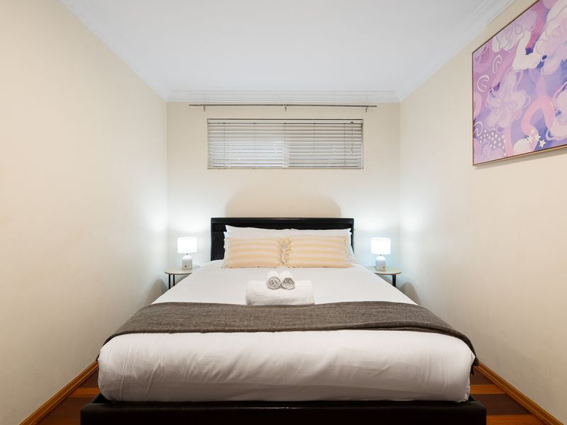 Comfortable bedroom featuring a clean bed setup and soft ambient lighting.