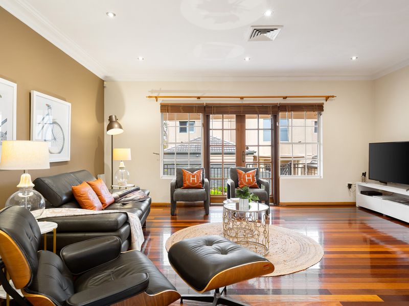 Living room area with a comfortable leather sofa and direct access to outdoor views.