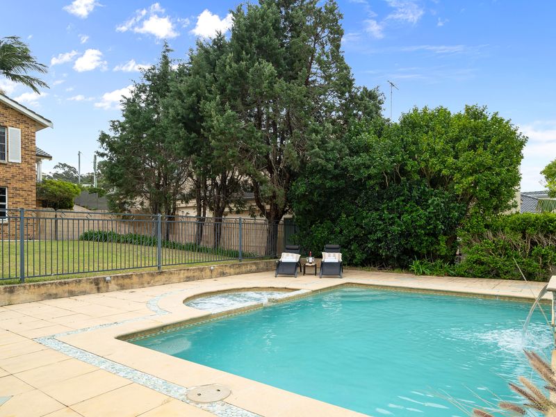 Sparkling swimming pool and spa nestled in the backyard garden.