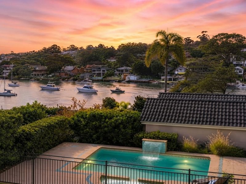 Scenic coastal view overlooking the water and shoreline at sunset.