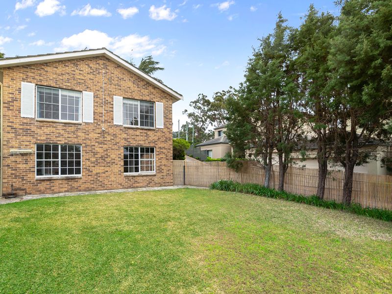 Lush green front lawn and landscaping surrounding the property.