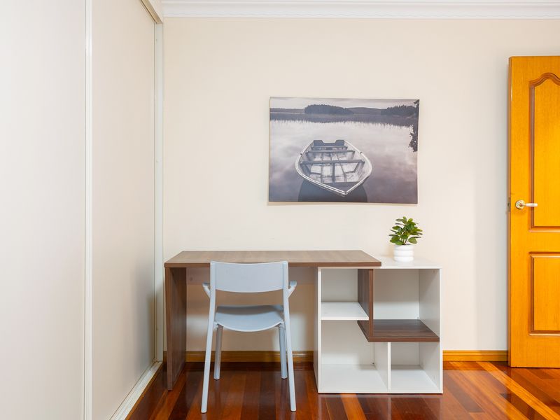 Functional home office and desk workspace with wall art and natural light.