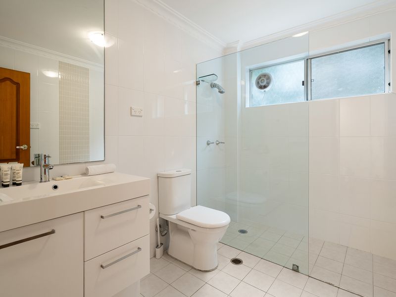 Clean bathroom featuring a white vanity counter, modern sink, and toilet.
