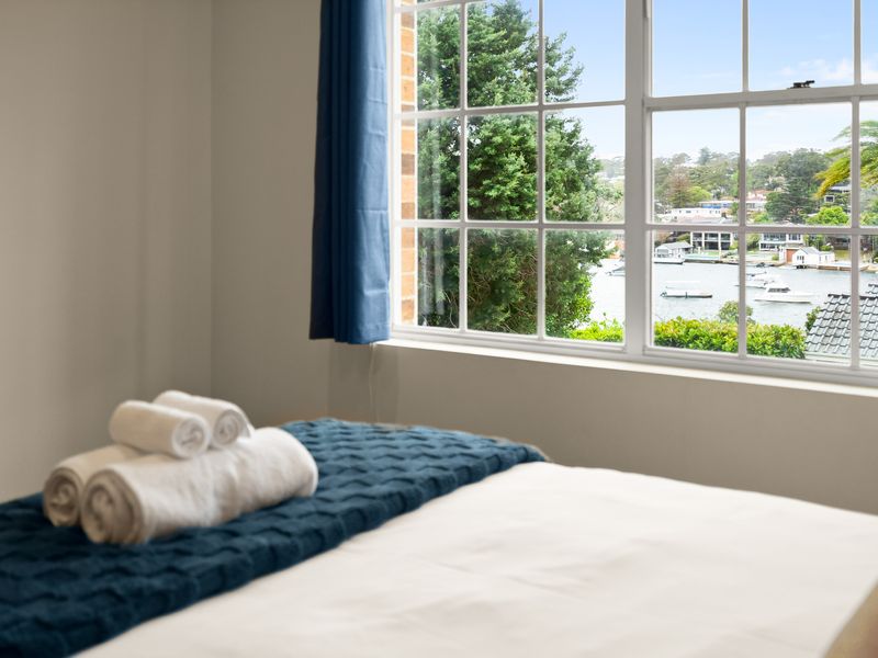 Bedroom featuring a blue accent throw blanket and side table lamps.