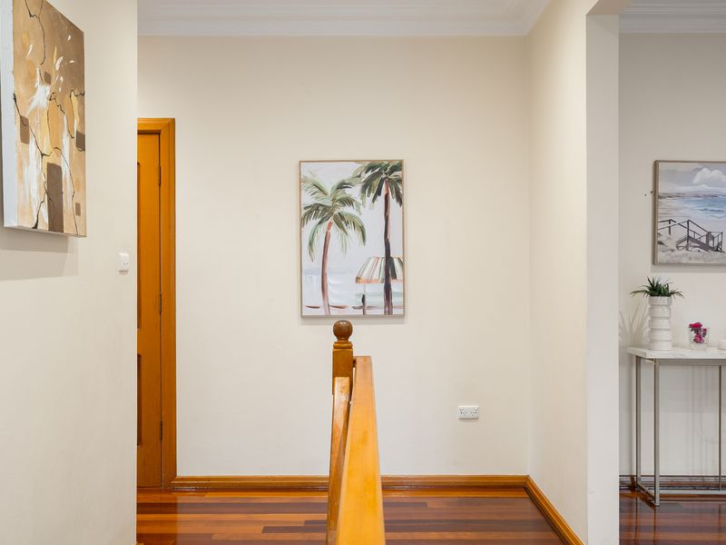 Bright interior hallway featuring a clean white wall and minimalist decor.
