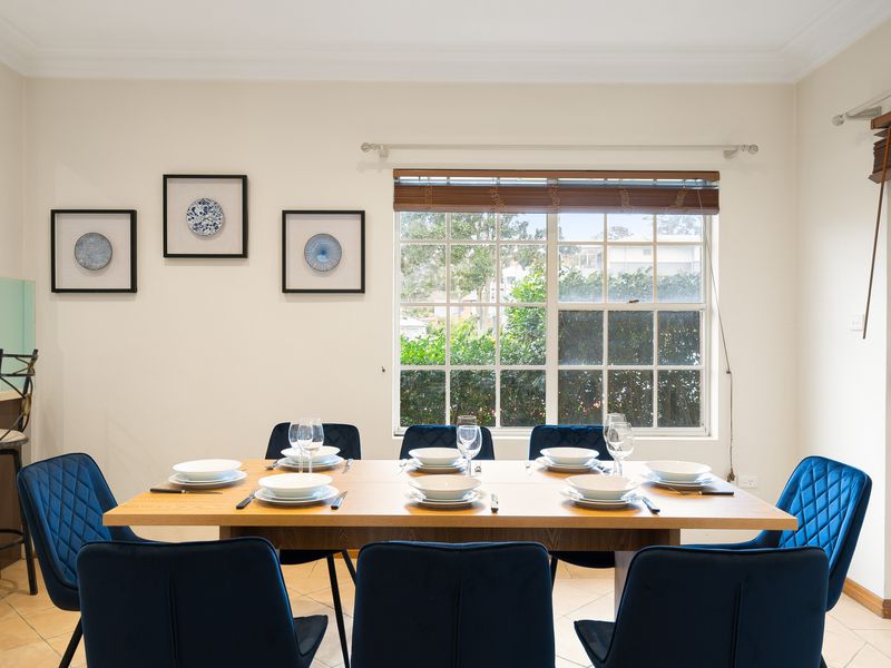 Elegant indoor dining table set beneath framed wall art.
