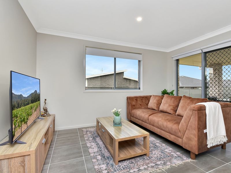 Inviting living room with plush seating and a large TV