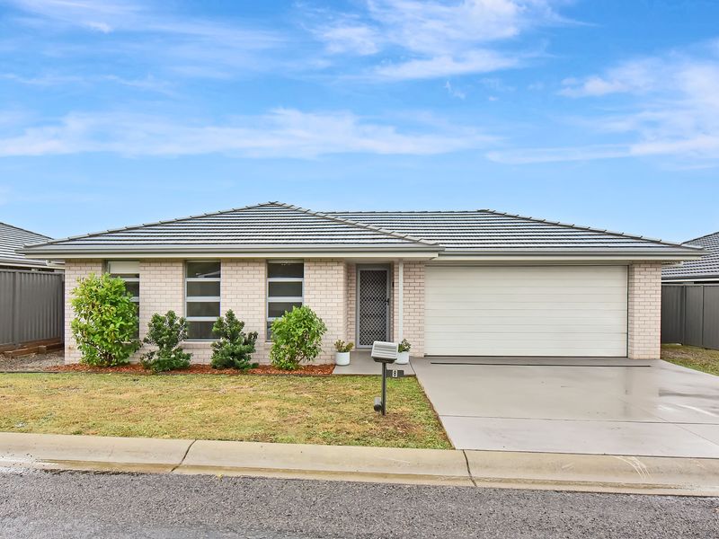 Charming front exterior with neat landscaping and driveway parking