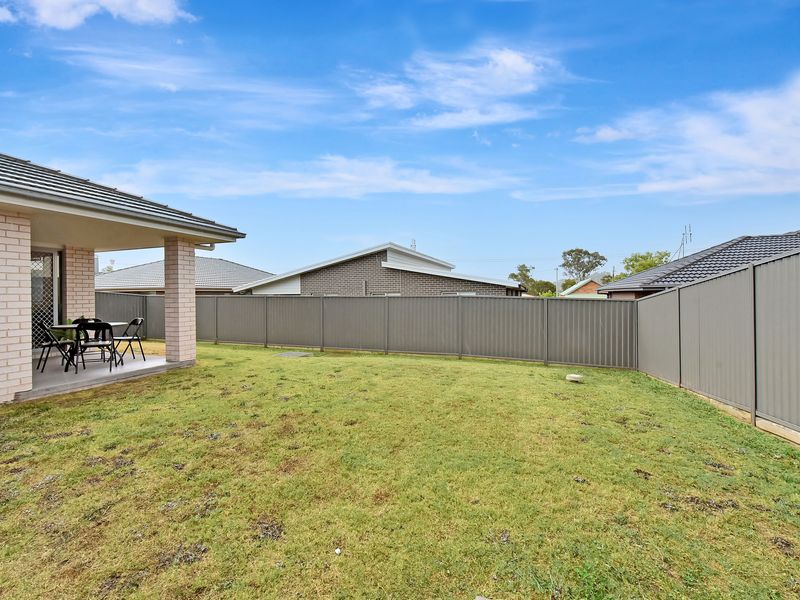 Covered outdoor patio with seating — great for morning coffee