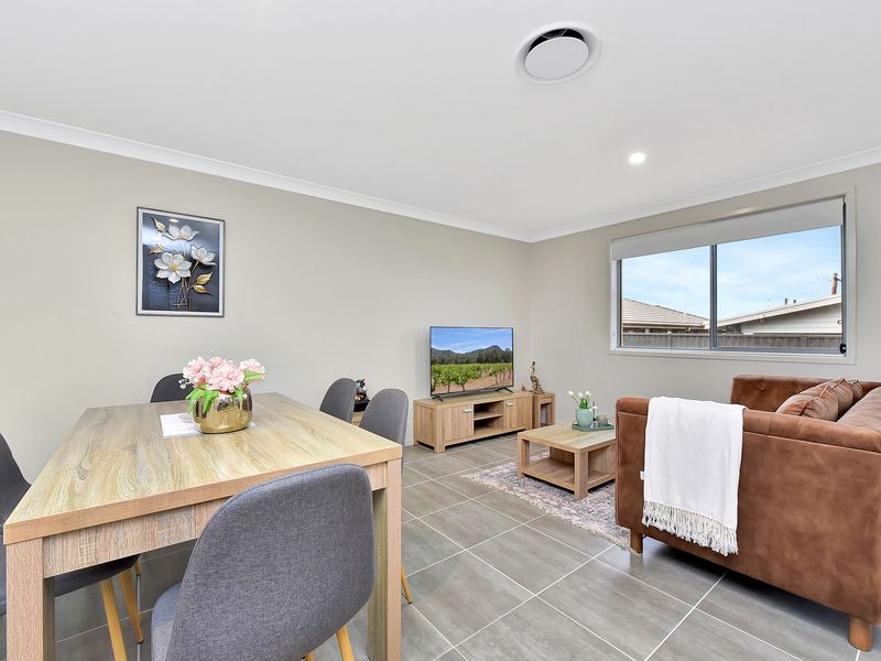 Bright open-plan living and dining area with cozy seating and a relaxing view — perfect for unwinding after a day out.