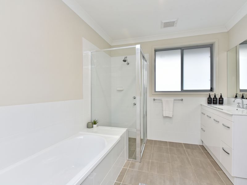 Sparkling clean bathroom with full bathtub and shower