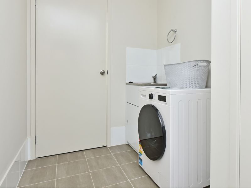 Bright laundry area with modern washer for easy, comfortable stay