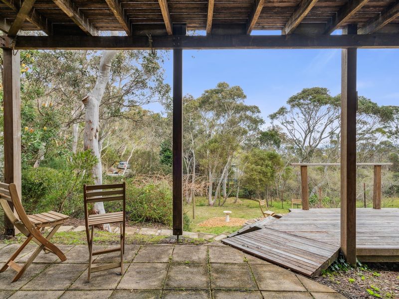 Outdoor seating area with two chairs set among the natural surrounds.