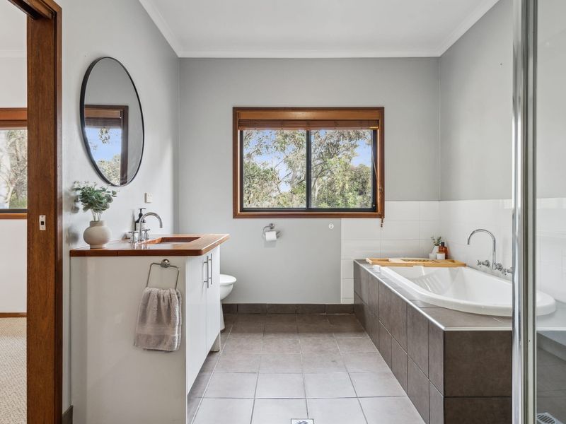 Bright bathroom with separate shower and bathtub.