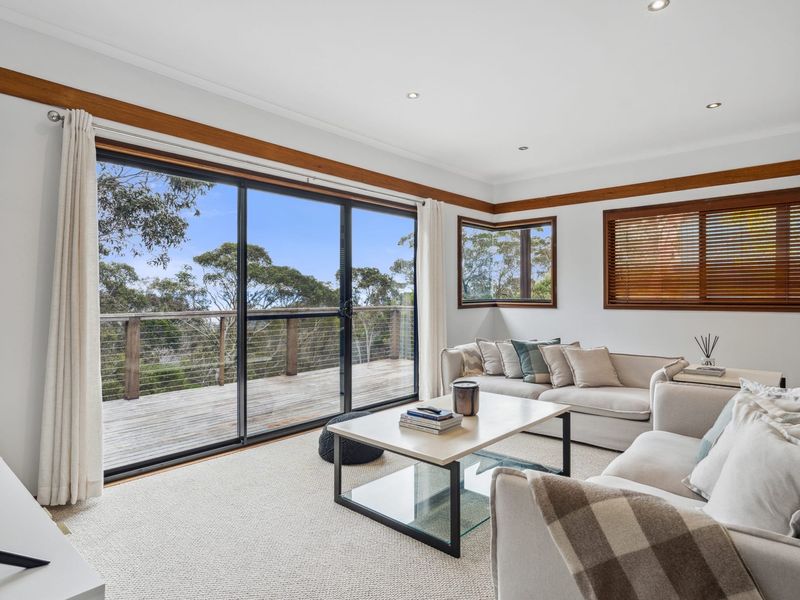 Cozy main lounge with valley glimpses through large windows.