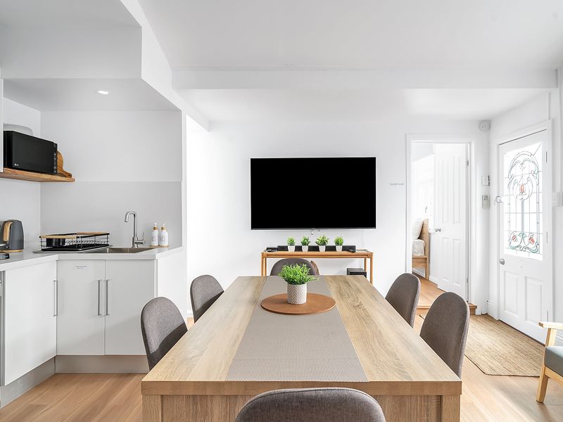 Open living zone with seating, dining, and kitchen in one space.