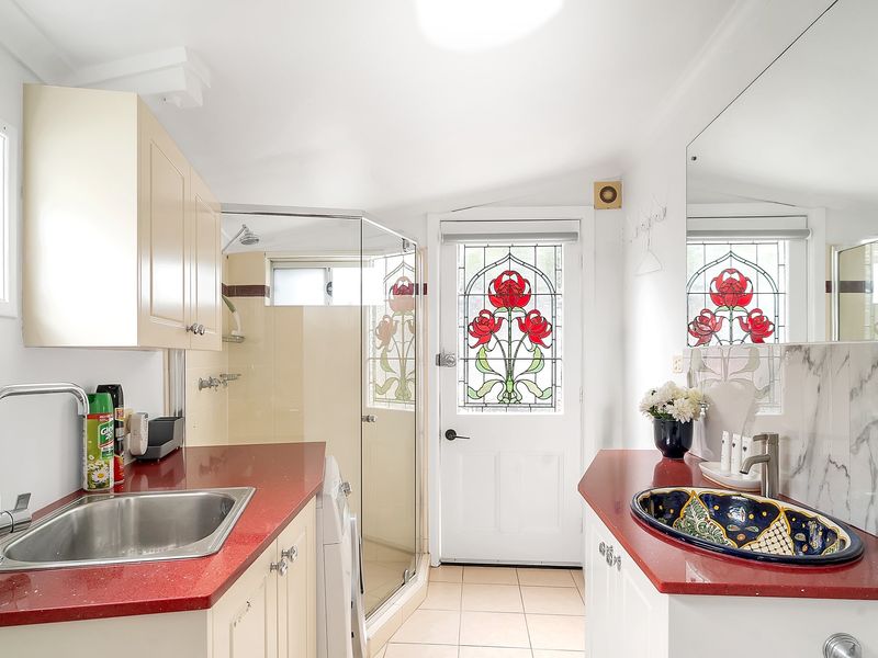 Vintage bathroom layout combined with a practical laundry setup.