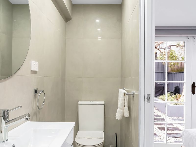 Fresh and compact ensuite bathroom for guest convenience.