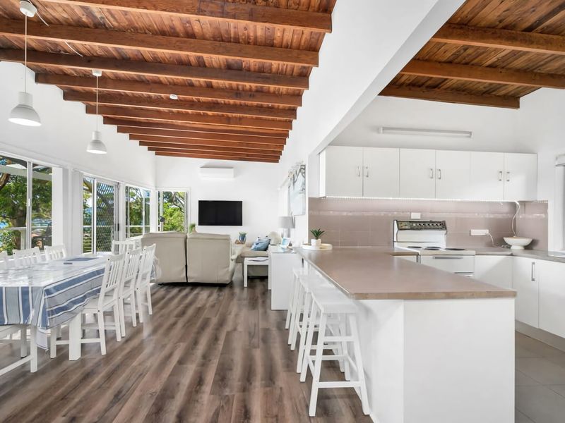 Open-plan living meets coastal charm with a light-filled kitchen and lounge.