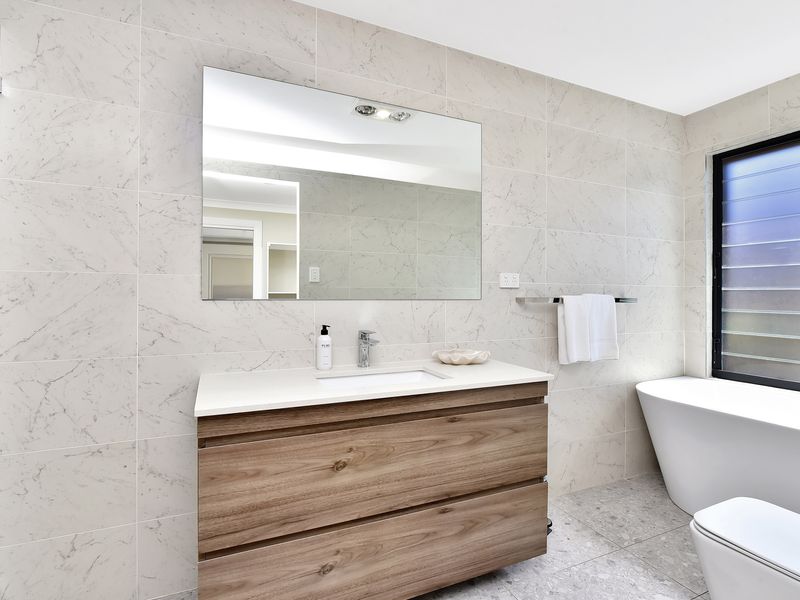 Bright and fresh design with marble-style tiles for a contemporary look.