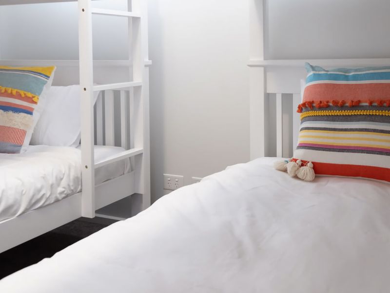 Brighten your stay with these crisp, comfortable bunk beds featuring playful, vibrant accents perfect for a restful getaway.