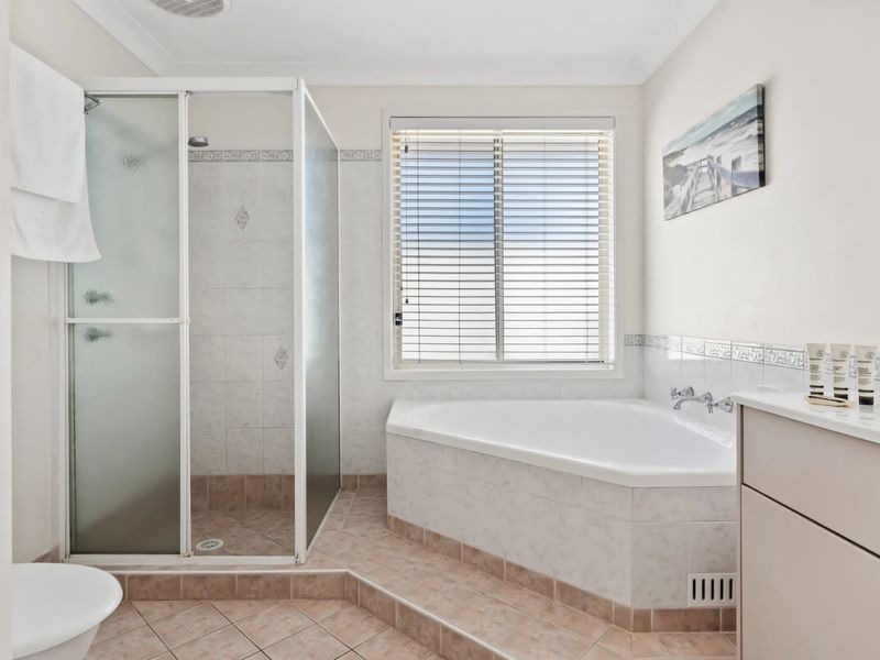 Bathroom with a bathtub and separate shower for added ease.