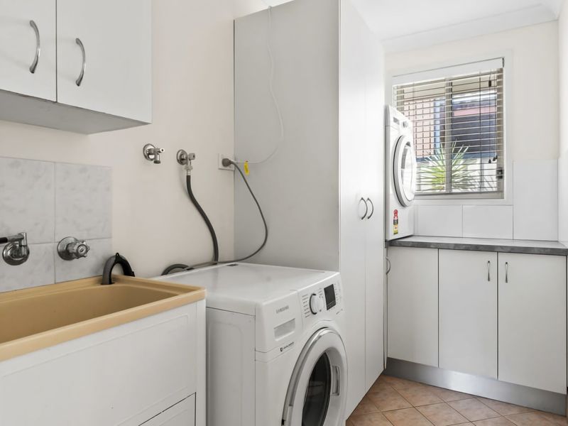Laundry area equipped with washer and dryer.