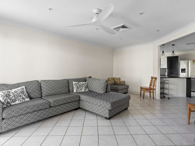 Cozy family room with sofa, smart TV, and Xbox for casual downtime.