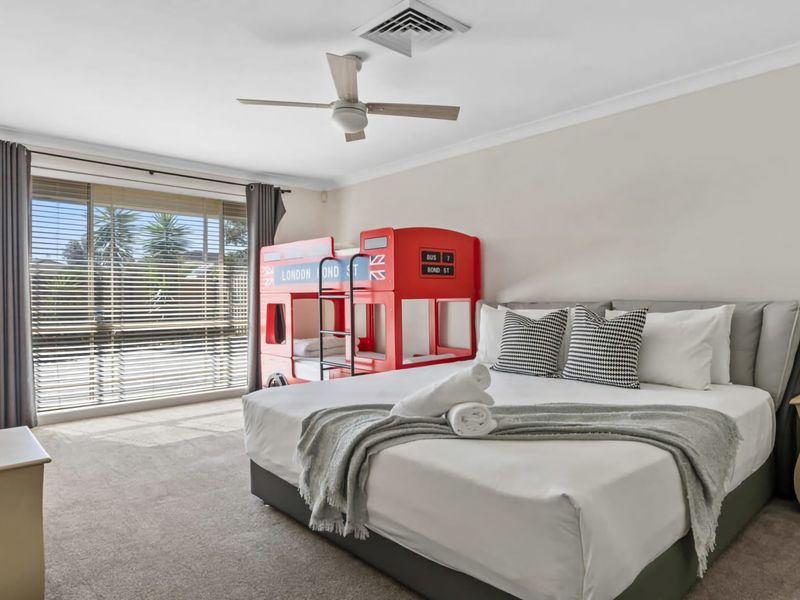 Spacious king bedroom with ceiling fan and private ensuite.