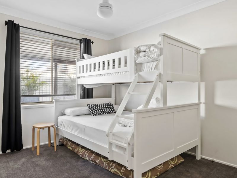 Cozy bedroom with double and single beds for added convenience.