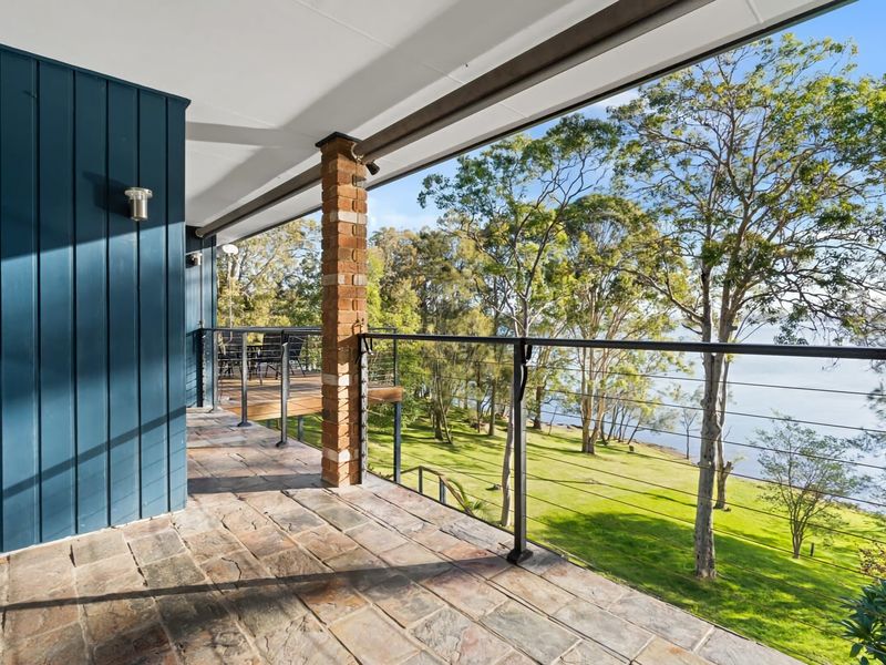 Balcony walkway with elevated water and garden views.