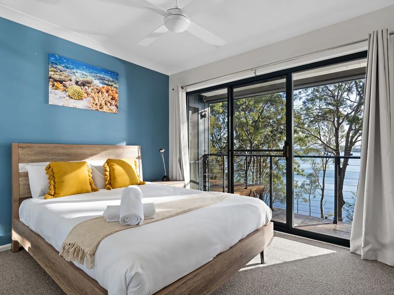 Comfortable bedroom with calming tones and outdoor access.