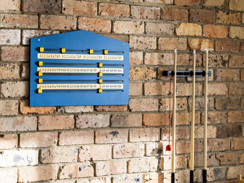 Pool cues and scoreboard ready for a friendly match.